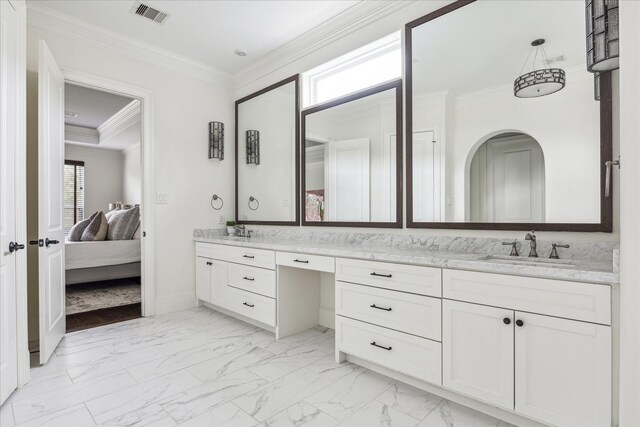 bathroom with marble finish floor, double vanity, ensuite bathroom, ornamental molding, and a sink