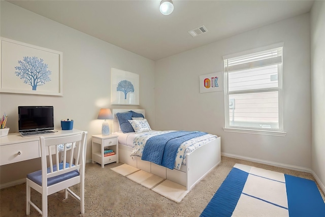 carpeted bedroom with visible vents and baseboards