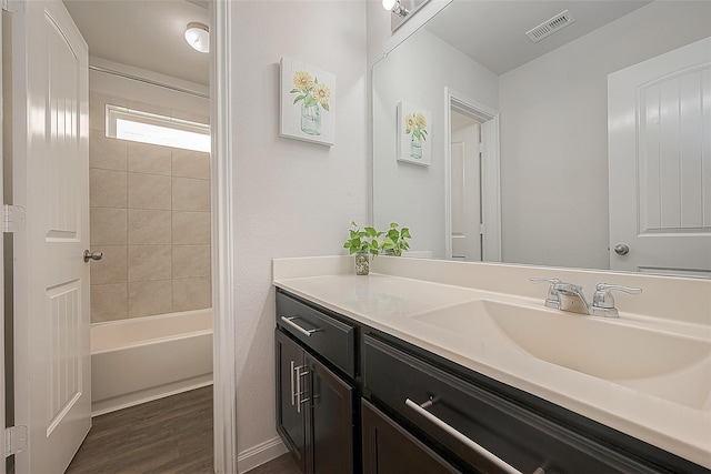 full bathroom featuring vanity, shower / tub combination, wood finished floors, and visible vents