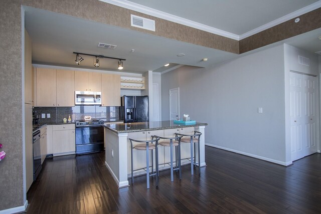 kitchen featuring electric range oven, black fridge with ice dispenser, dishwashing machine, stainless steel microwave, and a center island