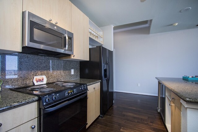 kitchen featuring tasteful backsplash, dark stone countertops, dark wood-type flooring, light brown cabinetry, and black appliances