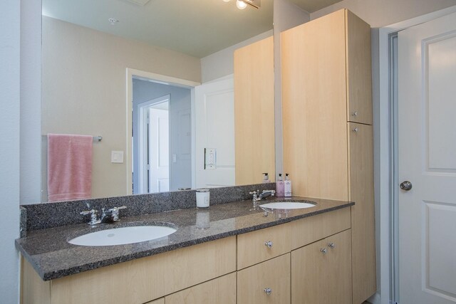 full bath with a sink and double vanity