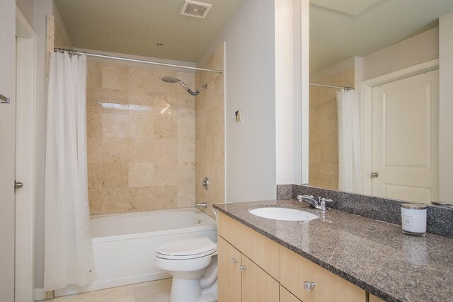 full bathroom with toilet, vanity, visible vents, tile patterned floors, and shower / bathtub combination with curtain