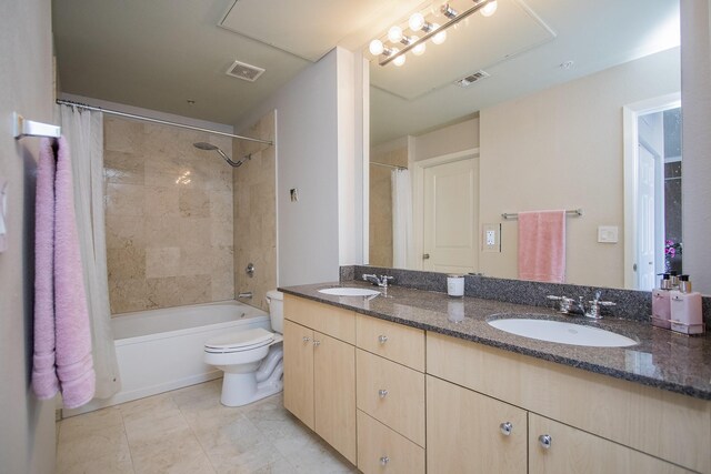 full bathroom with visible vents, a sink, and double vanity