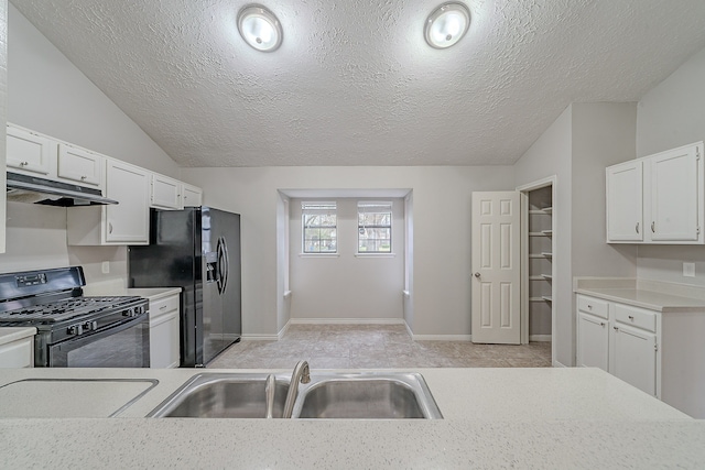 kitchen with lofted ceiling, black appliances, light countertops, and under cabinet range hood