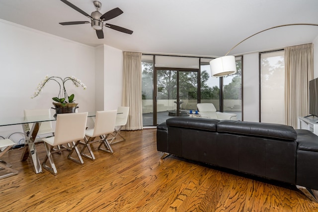 150 Gessner Rd Unit 4A, Houston, TX 77024 - living room featuring wood finished floors, a ceiling fan, floor to ceiling windows, and crown molding