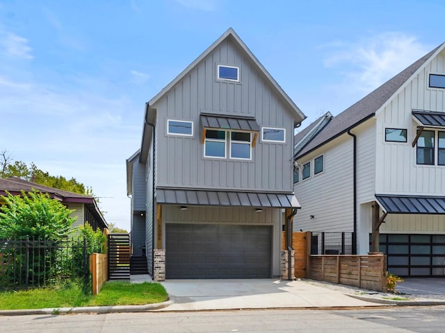 modern farmhouse with board and batten siding, a standing seam roof, metal roof, and a garage