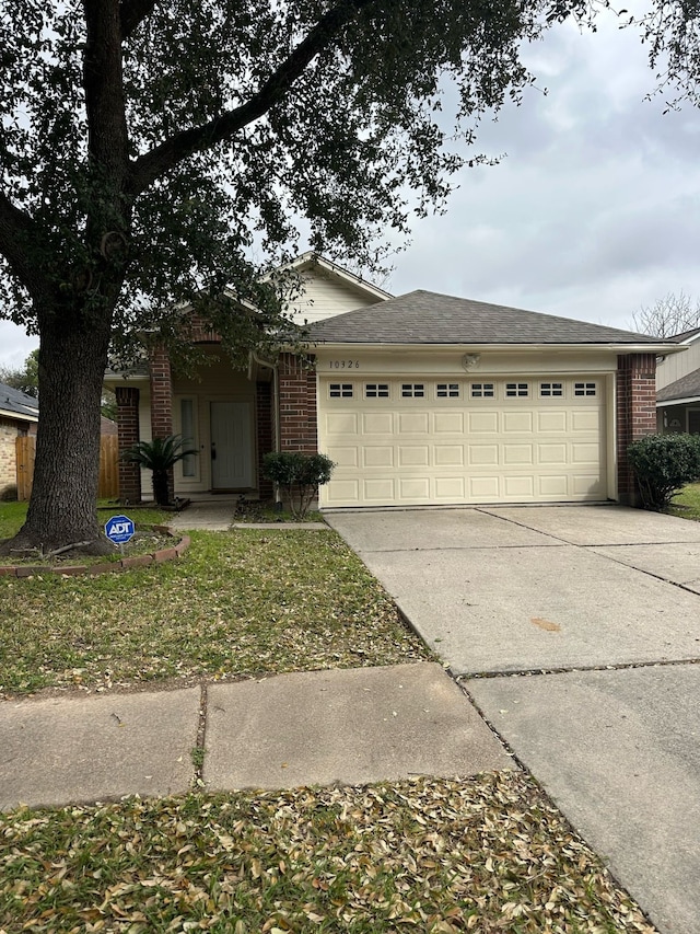 ranch-style house featuring a garage, concrete driveway, and brick siding