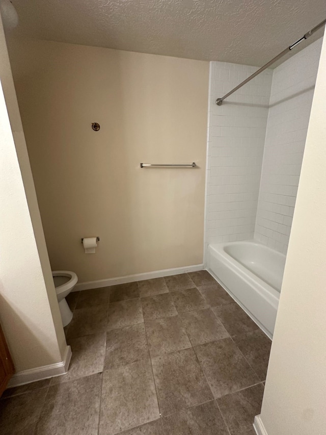 full bathroom featuring baseboards, toilet, a textured ceiling, and  shower combination