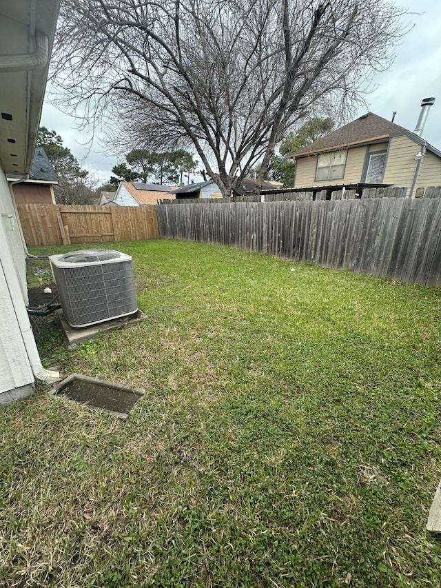 view of yard featuring a fenced backyard and central AC unit