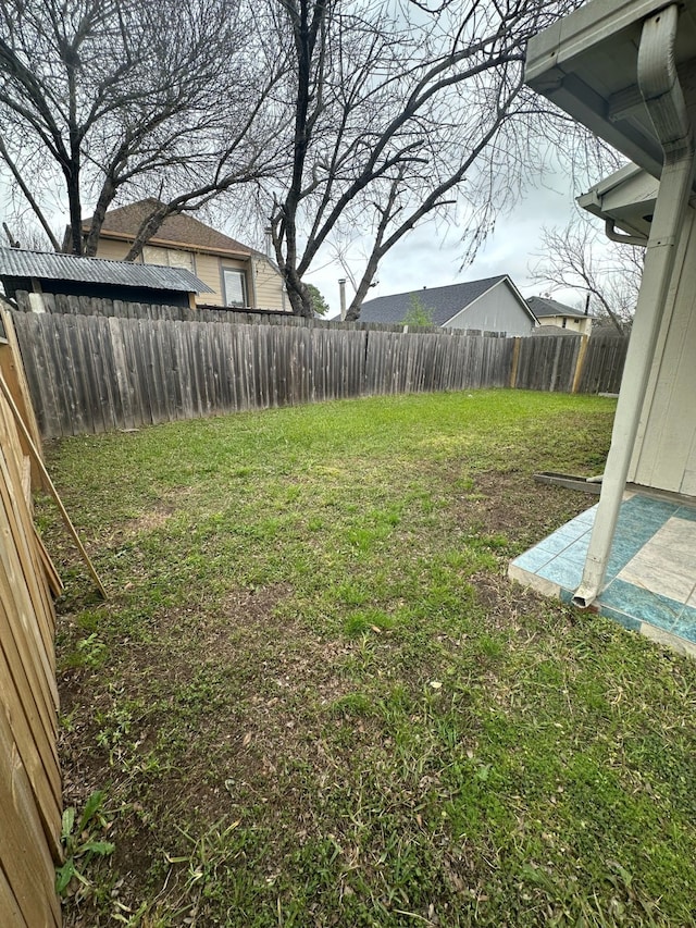 view of yard with a fenced backyard