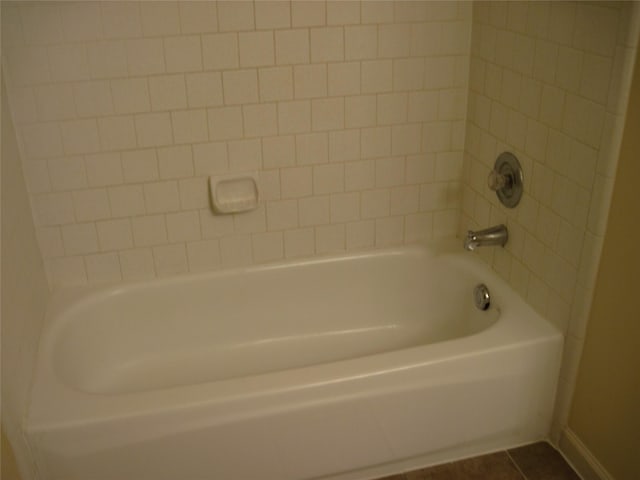 full bath with tile patterned floors, tub / shower combination, and baseboards