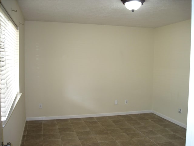spare room featuring baseboards