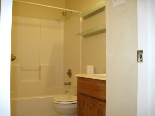 bathroom featuring vanity, shower / bathing tub combination, and toilet