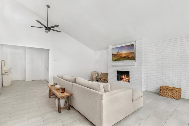 living area with a ceiling fan, brick wall, a fireplace, high vaulted ceiling, and light tile patterned flooring