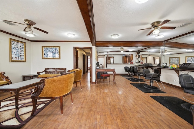 7828 Harrisburg Blvd, Houston, TX 77012 - dining area with crown molding, a textured ceiling, and light wood finished floors