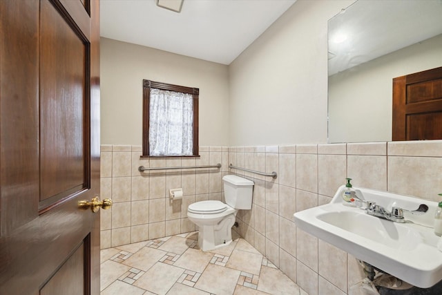7828 Harrisburg Blvd, Houston, TX 77012 - half bath with toilet, tile patterned flooring, tile walls, and a sink