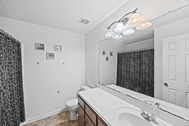 full bath featuring baseboards, visible vents, toilet, a textured ceiling, and vanity