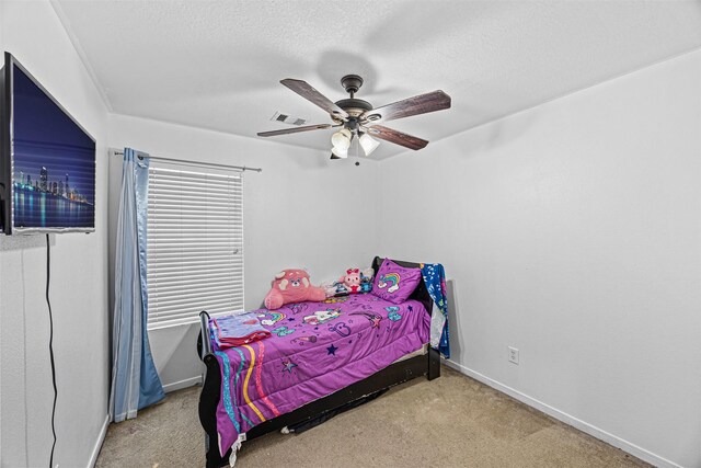 bedroom with light carpet, a textured ceiling, visible vents, and baseboards