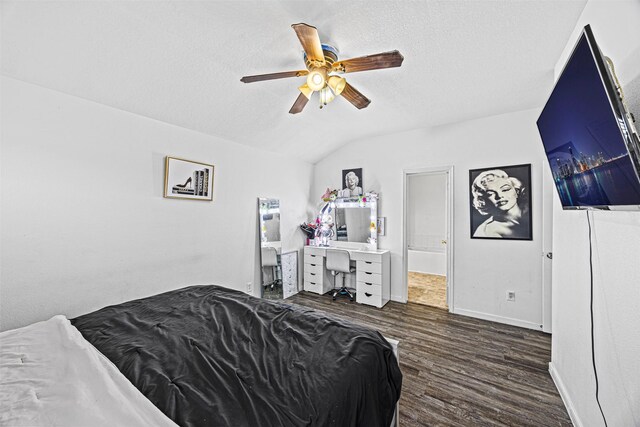 bedroom with dark wood-style floors, baseboards, vaulted ceiling, and a textured ceiling