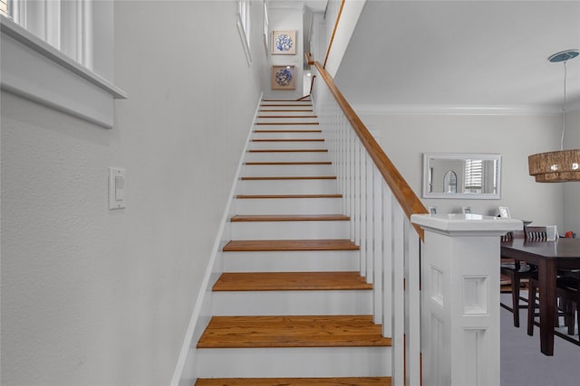 stairway featuring crown molding