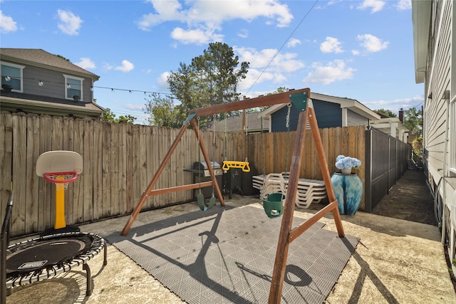 view of play area with a fenced backyard and a patio