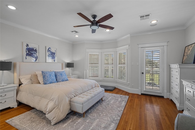 bedroom featuring access to exterior, visible vents, crown molding, and wood finished floors