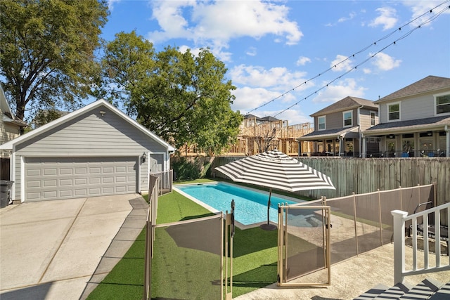 view of swimming pool featuring an outbuilding, a fenced backyard, and a fenced in pool