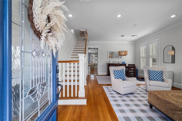 interior space with crown molding, recessed lighting, stairway, wood finished floors, and baseboards