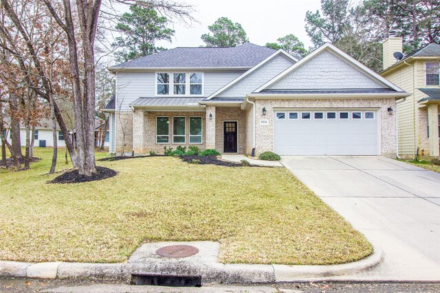 view of front of house with a front lawn, concrete driveway, brick siding, and an attached garage