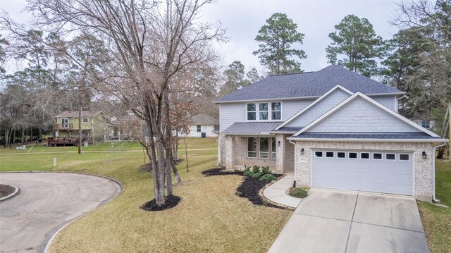 traditional home featuring brick siding, a shingled roof, an attached garage, driveway, and a front lawn