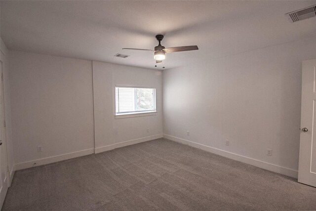 unfurnished room with ceiling fan, carpet, visible vents, and baseboards