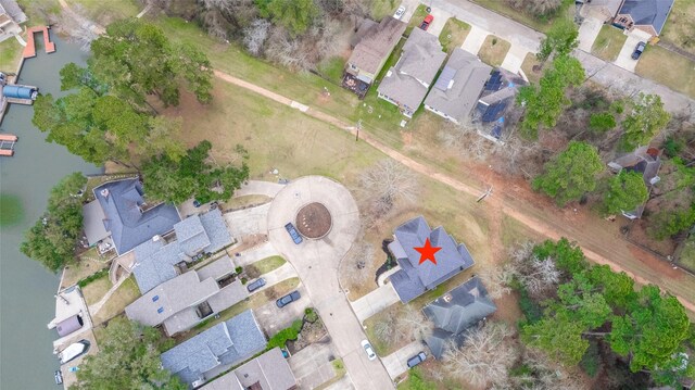 drone / aerial view featuring a water view and a residential view