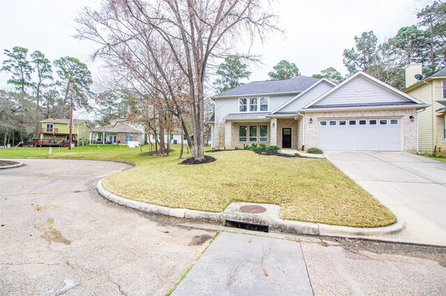 view of front of house with a garage, a front lawn, concrete driveway, and brick siding