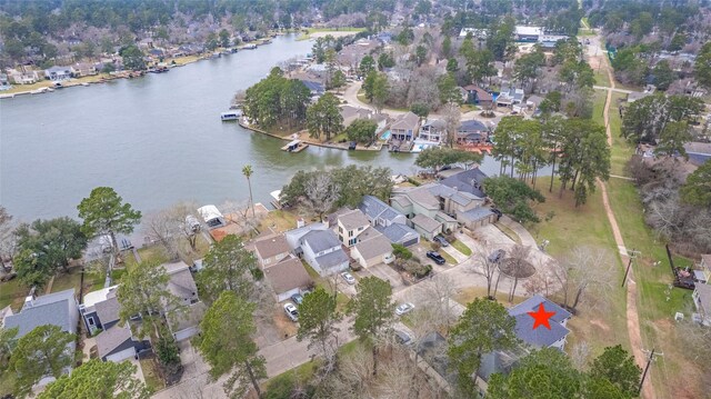 drone / aerial view featuring a residential view and a water view