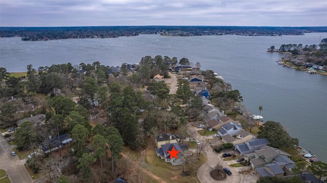 drone / aerial view featuring a residential view and a water view