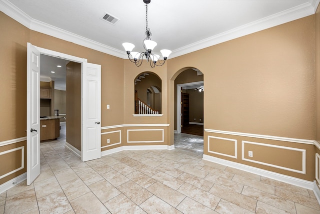 empty room with visible vents, arched walkways, a decorative wall, and ornamental molding