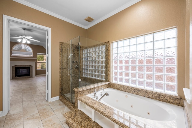bathroom with a stall shower, a glass covered fireplace, ceiling fan, tile patterned floors, and crown molding
