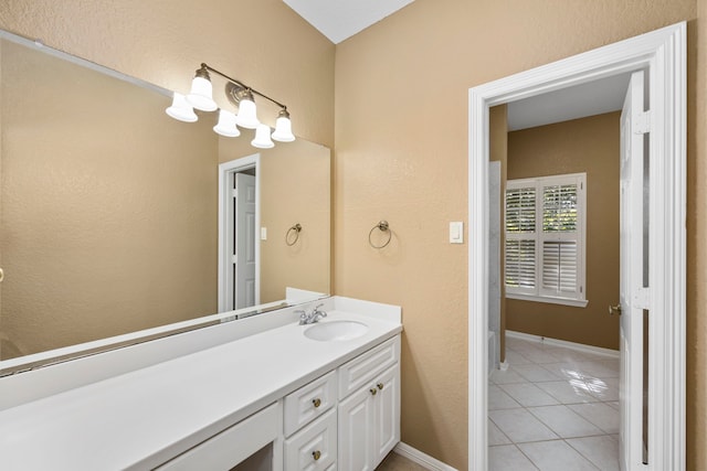 bathroom featuring tile patterned floors, baseboards, and vanity