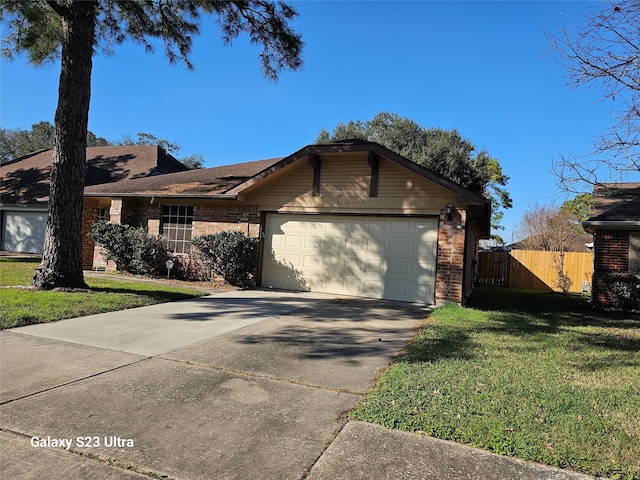 ranch-style home with an attached garage, fence, concrete driveway, and a front yard