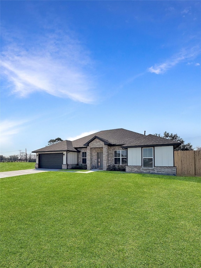 view of front facade with board and batten siding, fence, a garage, driveway, and a front lawn