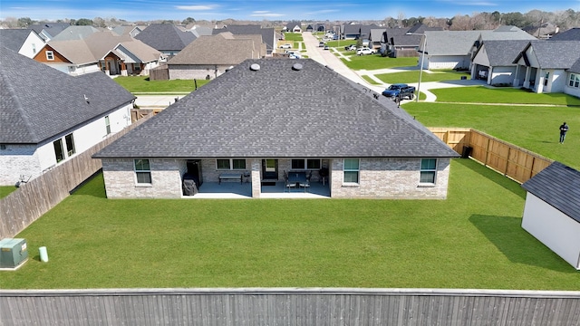 rear view of house featuring a shingled roof, a residential view, and brick siding