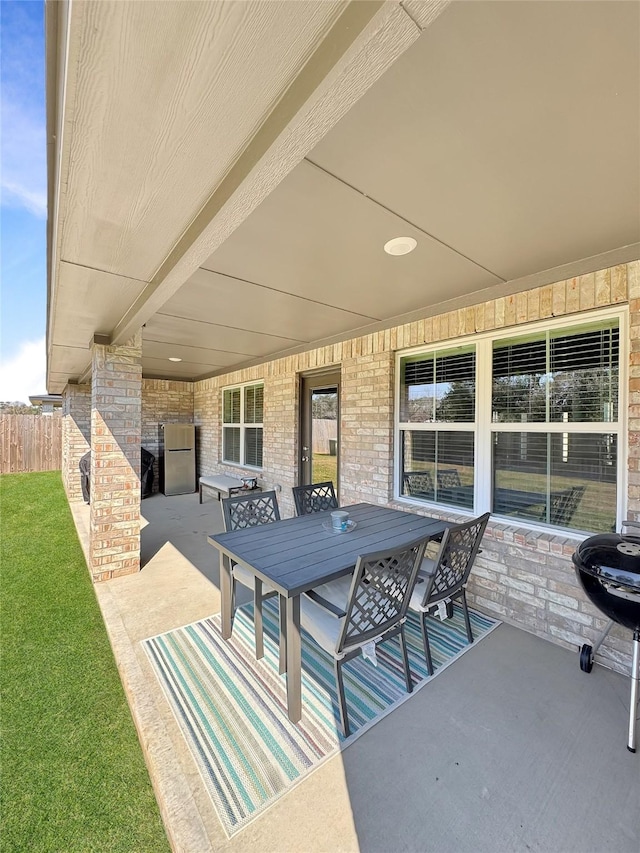 view of patio / terrace featuring outdoor dining area, area for grilling, and fence