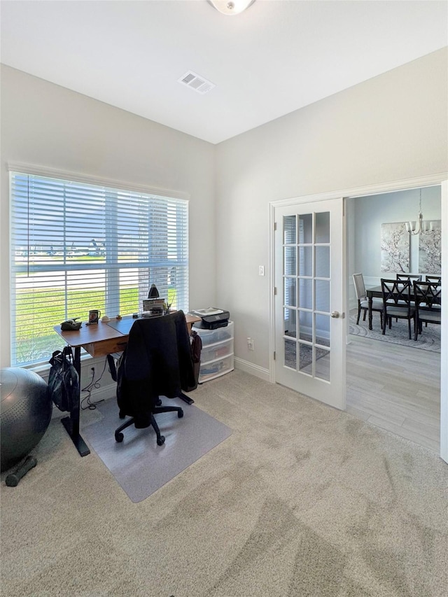 office area with carpet floors, visible vents, and baseboards