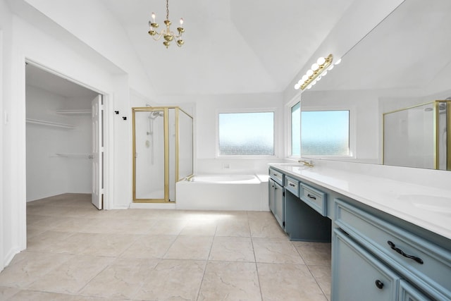 full bathroom with double vanity, a shower stall, and lofted ceiling