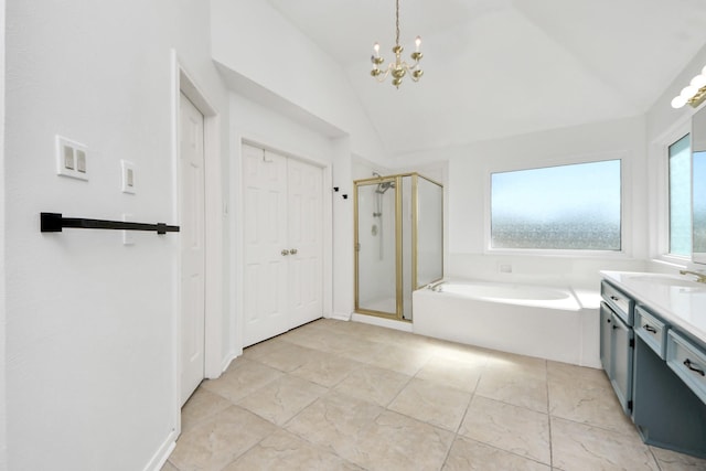 bathroom featuring a notable chandelier, lofted ceiling, vanity, a shower stall, and a bath