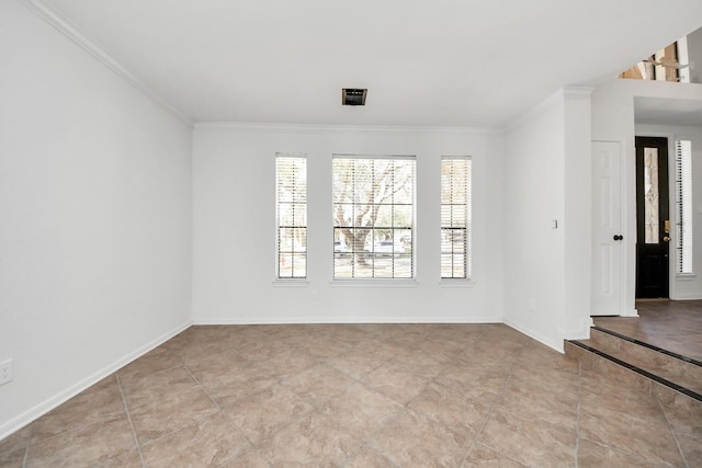 spare room with ornamental molding, visible vents, and baseboards