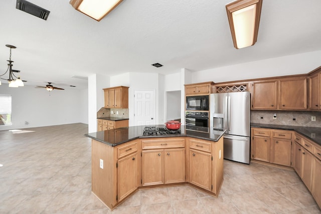 kitchen with black appliances, tasteful backsplash, visible vents, and a center island