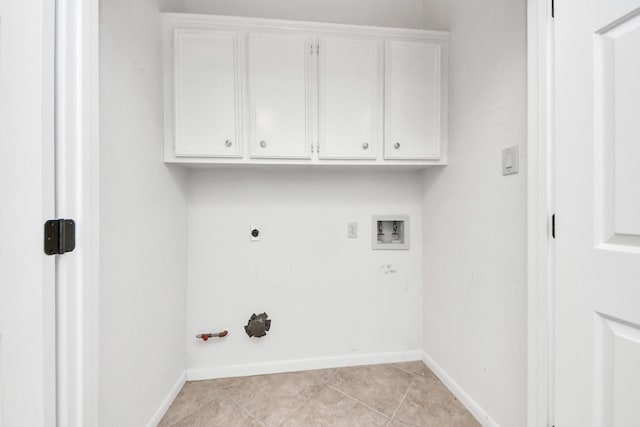 laundry room with gas dryer hookup, light tile patterned flooring, cabinet space, and baseboards