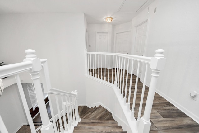 stairway featuring wood finished floors and baseboards